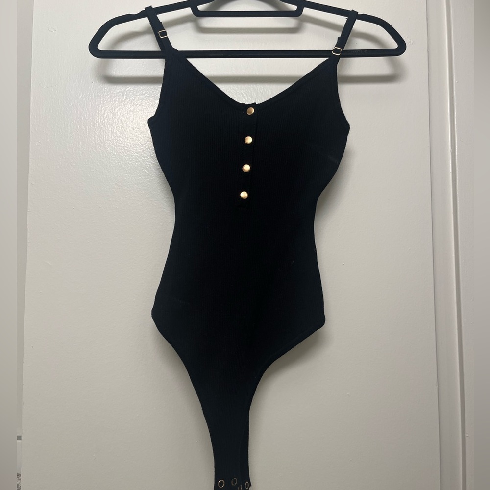 Black bodysuit, gold buttons on front